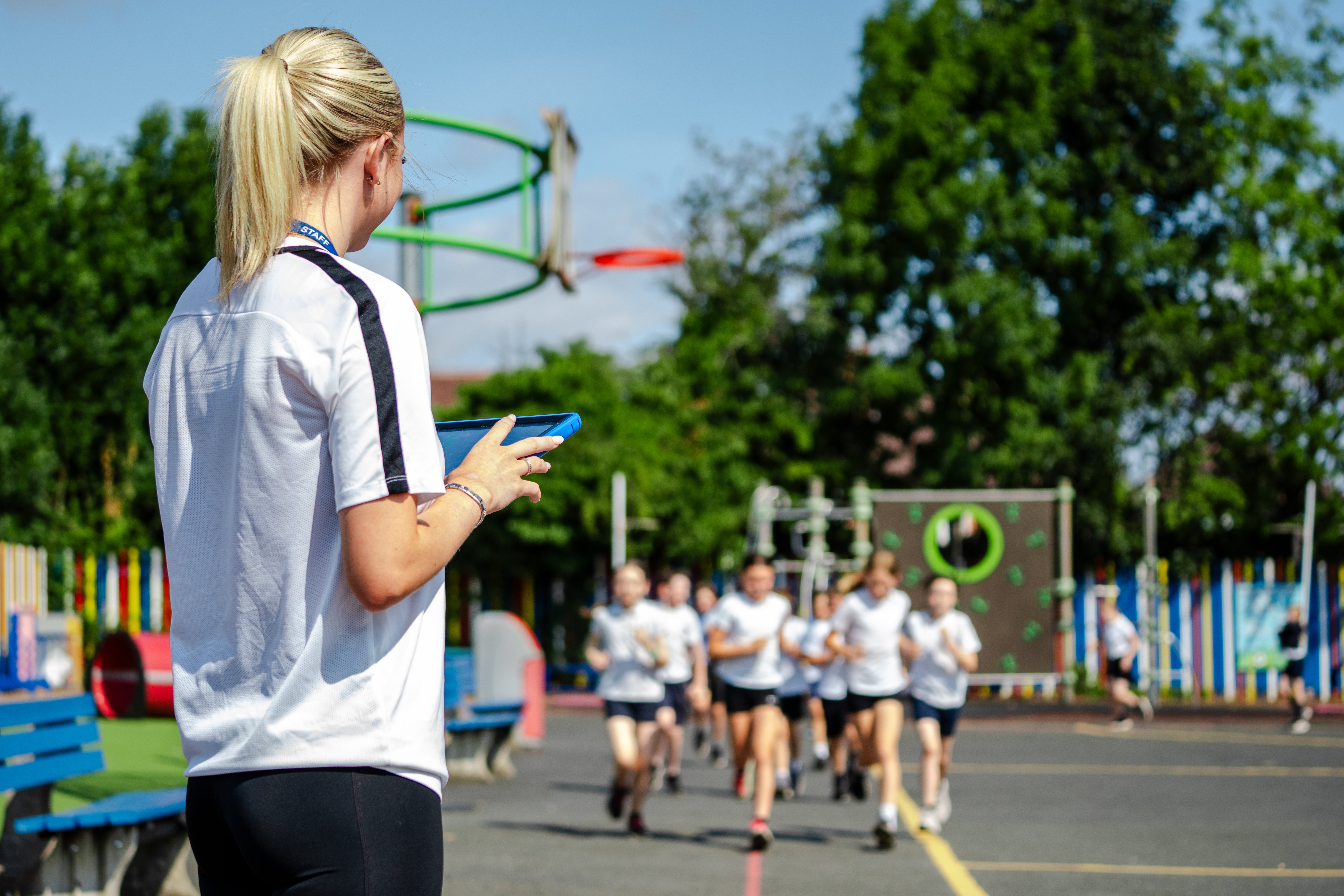 RunEd female teacher and runners on playground