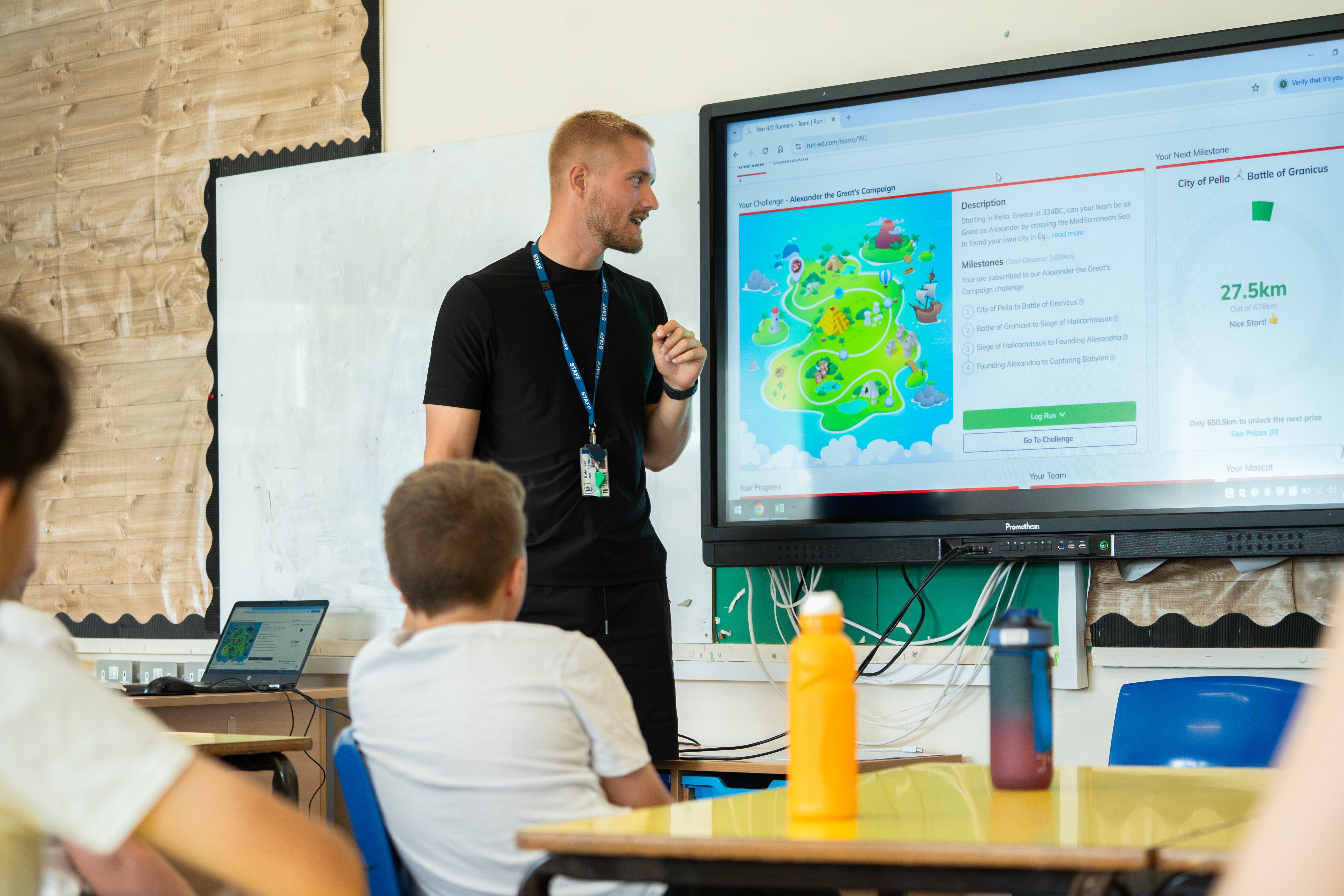 RunEd male teacher with pupils in classroom